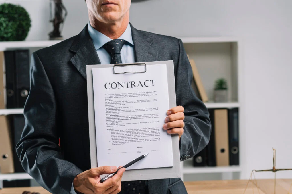 Close up lawyer showing legal contract agreement with pen 1024x683 1